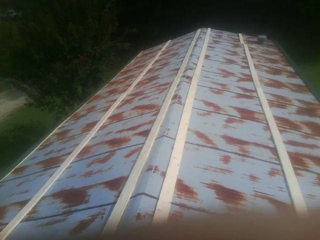 Rusted metal roof panels with new wood purlins before replacement — Storm Damage Roof Repair in Herald by Roofing Brothers