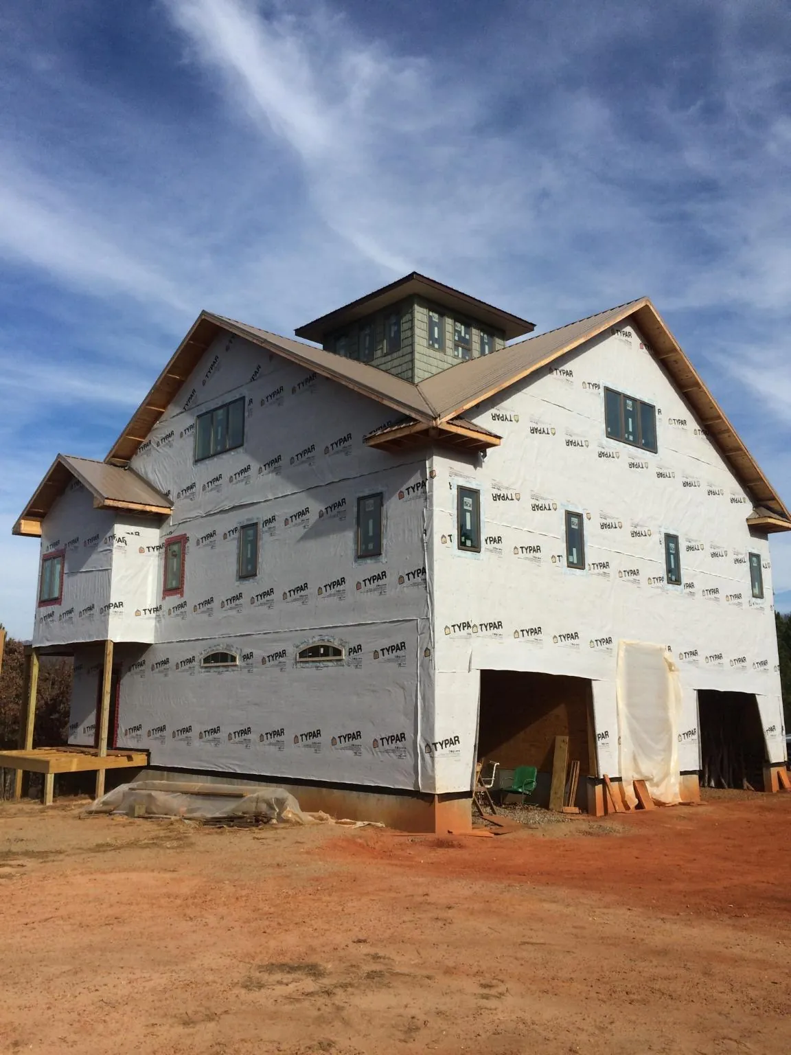 New two story house under construction with a cupola and gabled roofs in Herald